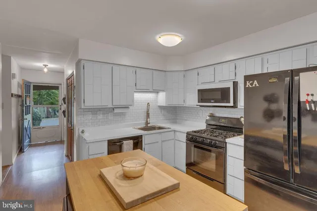 a kitchen with cabinets appliances and a counter space