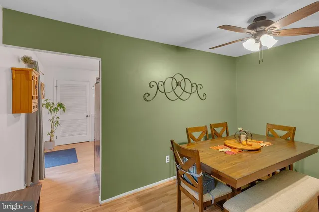 a view of a dining room with a table and chairs