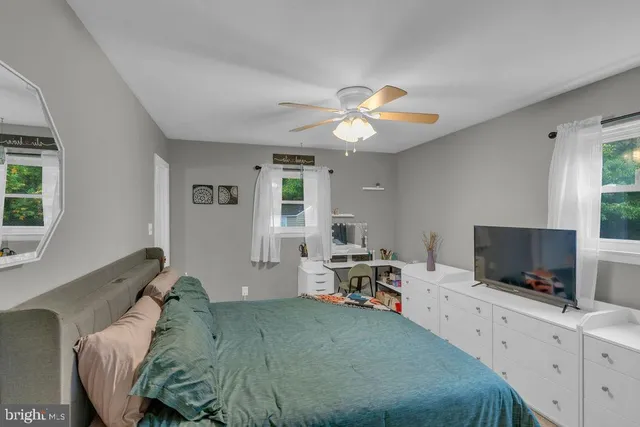 a bed room with furniture and a flat screen tv