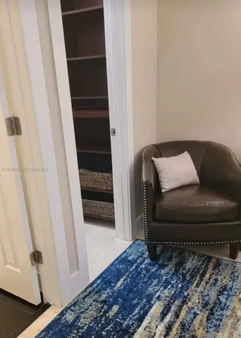 a living room with a couch and a rug