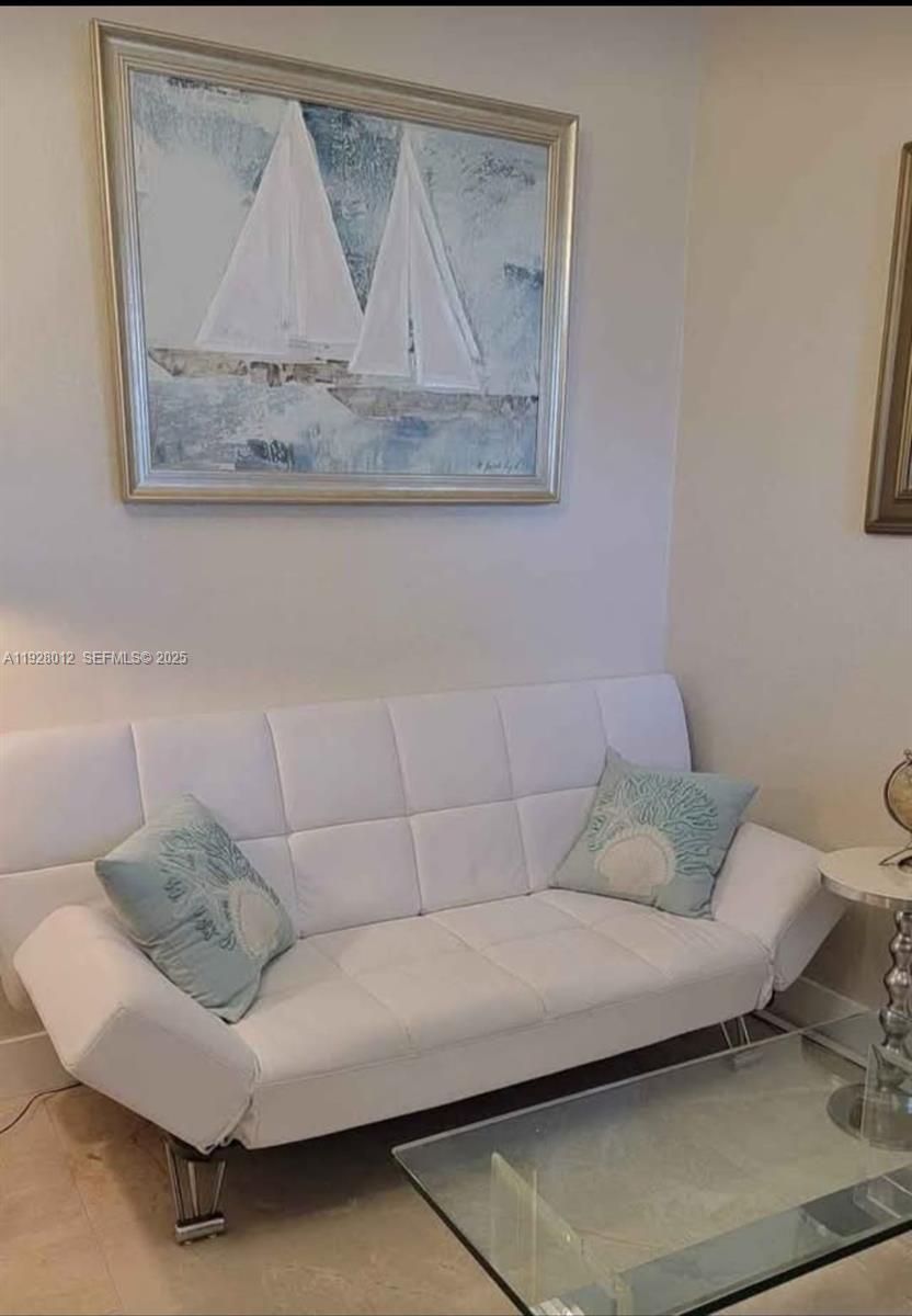 2228 Polk Street, Unit 7 Hollywood, FL 33020 - Photo 2 of 14 a living room with a couch and a table