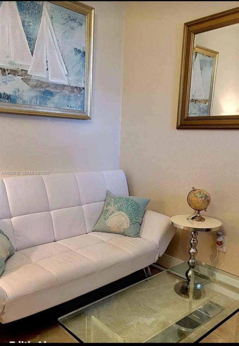 2228 Polk Street, Unit 7 Hollywood, FL 33020 - Photo 6 of 14 a living room with a couch and kitchen view