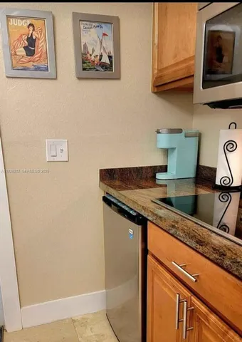 a kitchen with granite countertop cabinets and window