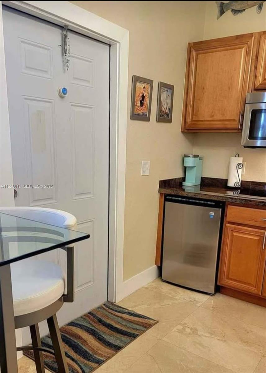 2228 Polk Street, Unit 7 Hollywood, FL 33020 - Photo 8 of 14 a kitchen with stainless steel appliances granite countertop a sink and a cabinets