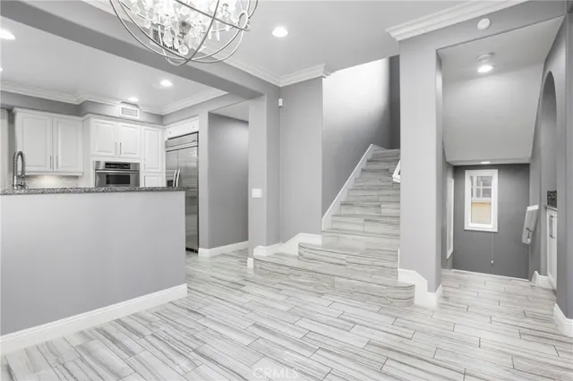 a view of a kitchen with wooden floor and staircase
