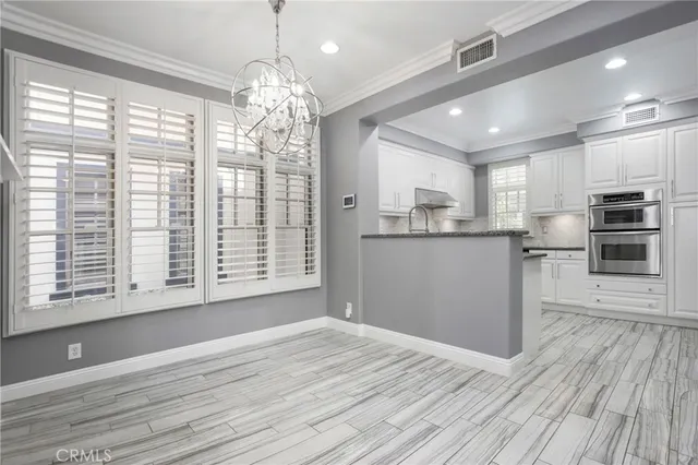 a view of a kitchen with microwave and cabinets