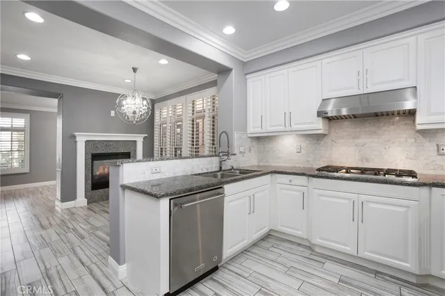 a kitchen with stainless steel appliances granite countertop a stove and a sink