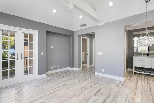 en empty room with wooden floor and sliding door