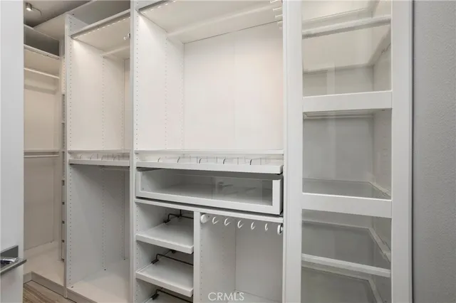 a close view of an empty room with a cabinet and a window