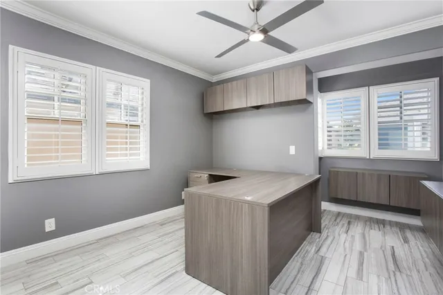 a kitchen with a stove a sink and wooden floor