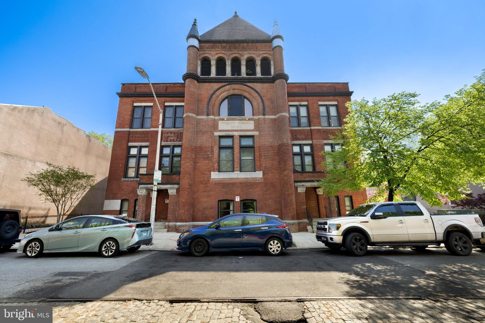 511 South Bond Street, Unit 302 Baltimore, MD 21231 - Photo 1 of 24 a car parked in front of a big house