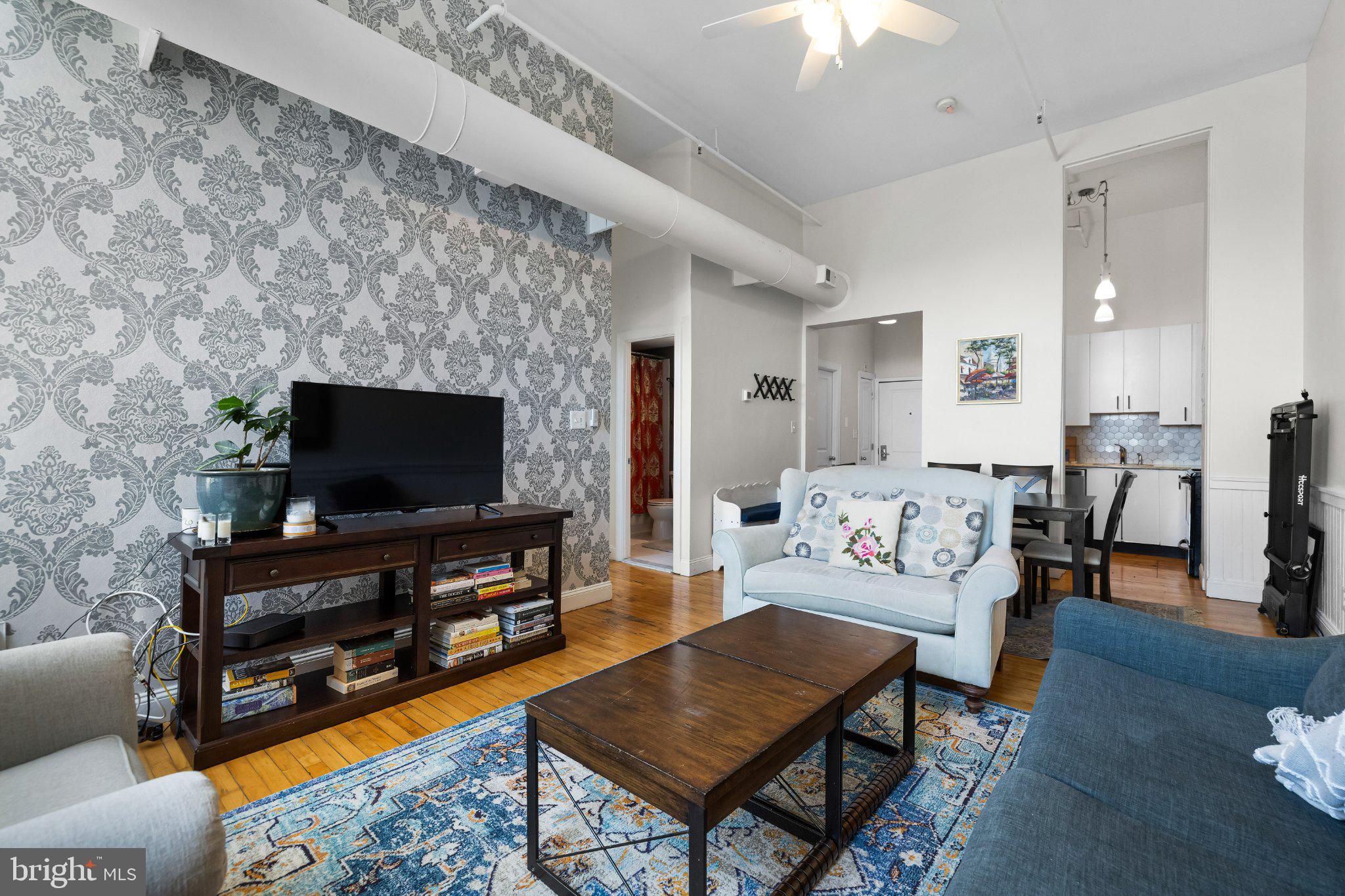 511 South Bond Street, Unit 302 Baltimore, MD 21231 - Photo 13 of 24 a living room with furniture and a flat screen tv