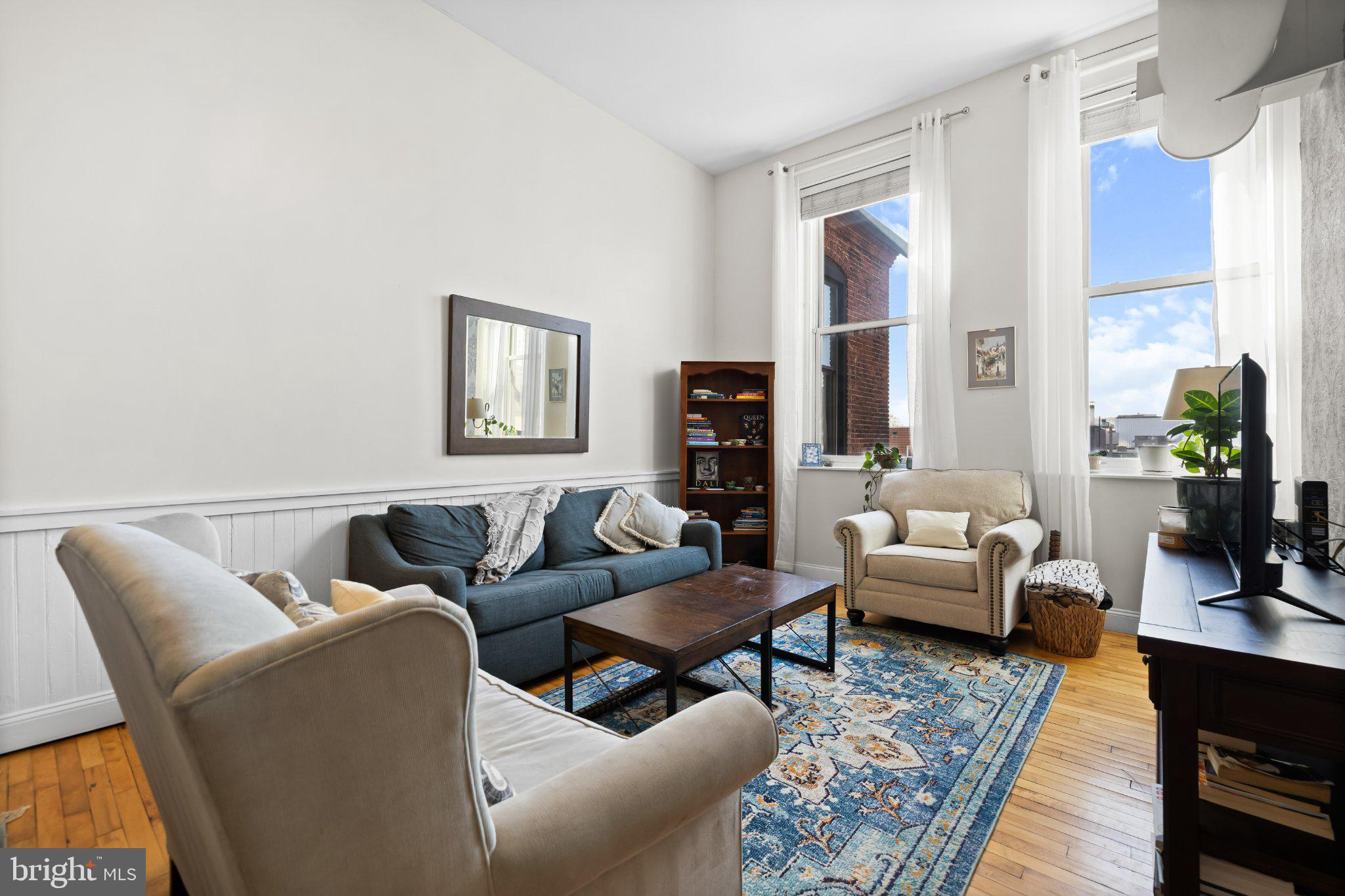 511 South Bond Street, Unit 302 Baltimore, MD 21231 - Photo 16 of 24 a living room with furniture wooden floor and a large window