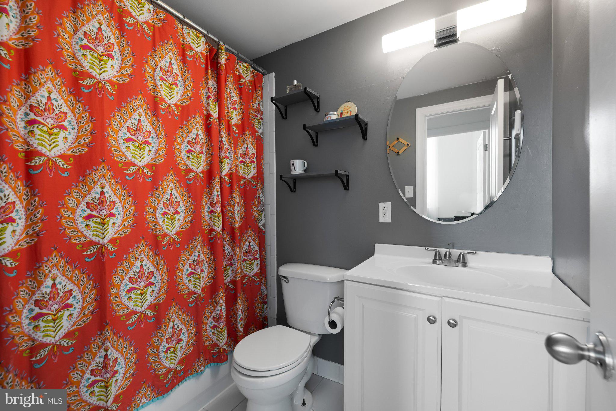511 South Bond Street, Unit 302 Baltimore, MD 21231 - Photo 17 of 24 a bathroom with a toilet sink and mirror