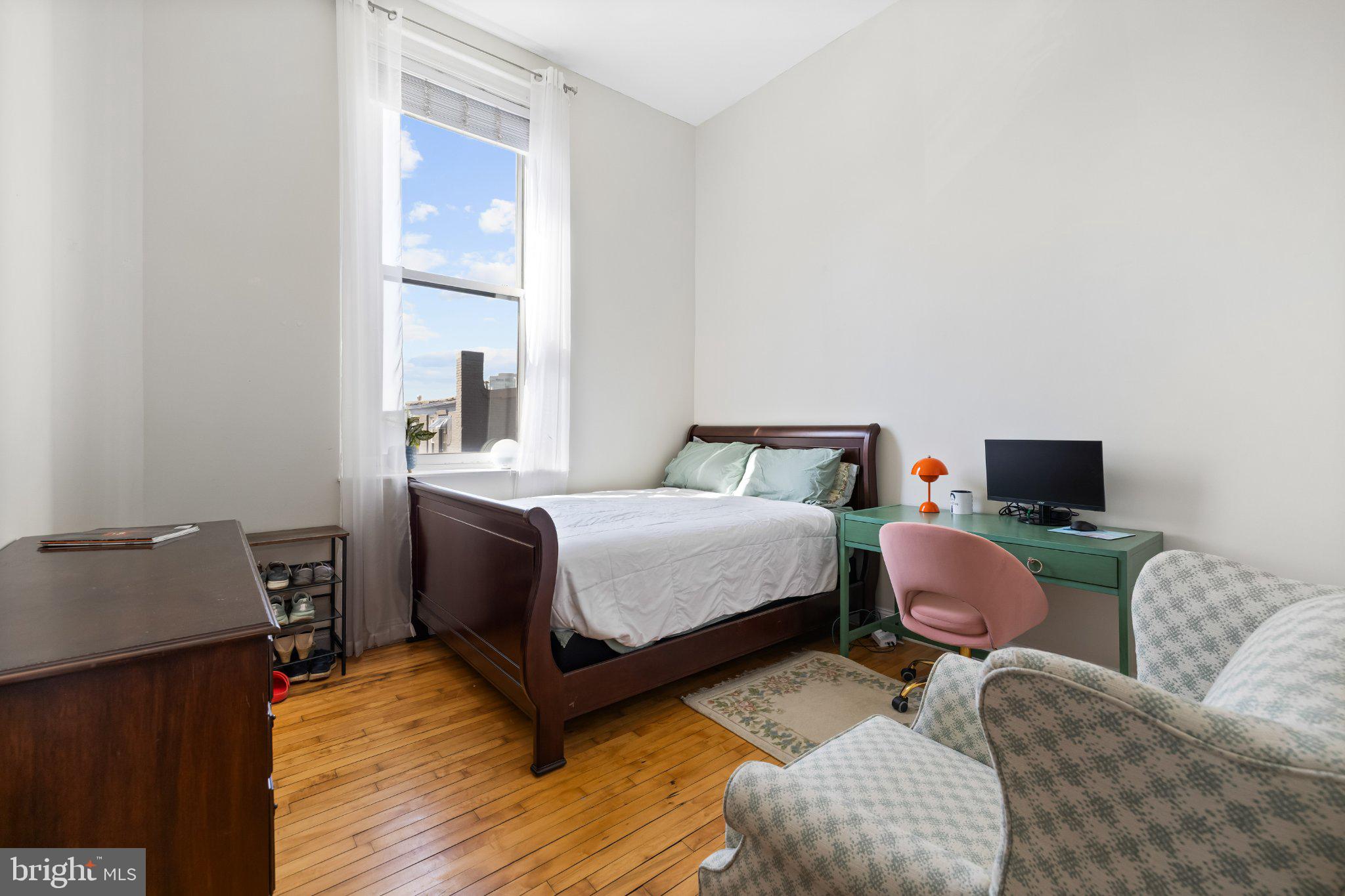 511 South Bond Street, Unit 302 Baltimore, MD 21231 - Photo 18 of 24 a bedroom with a bed and wooden floor