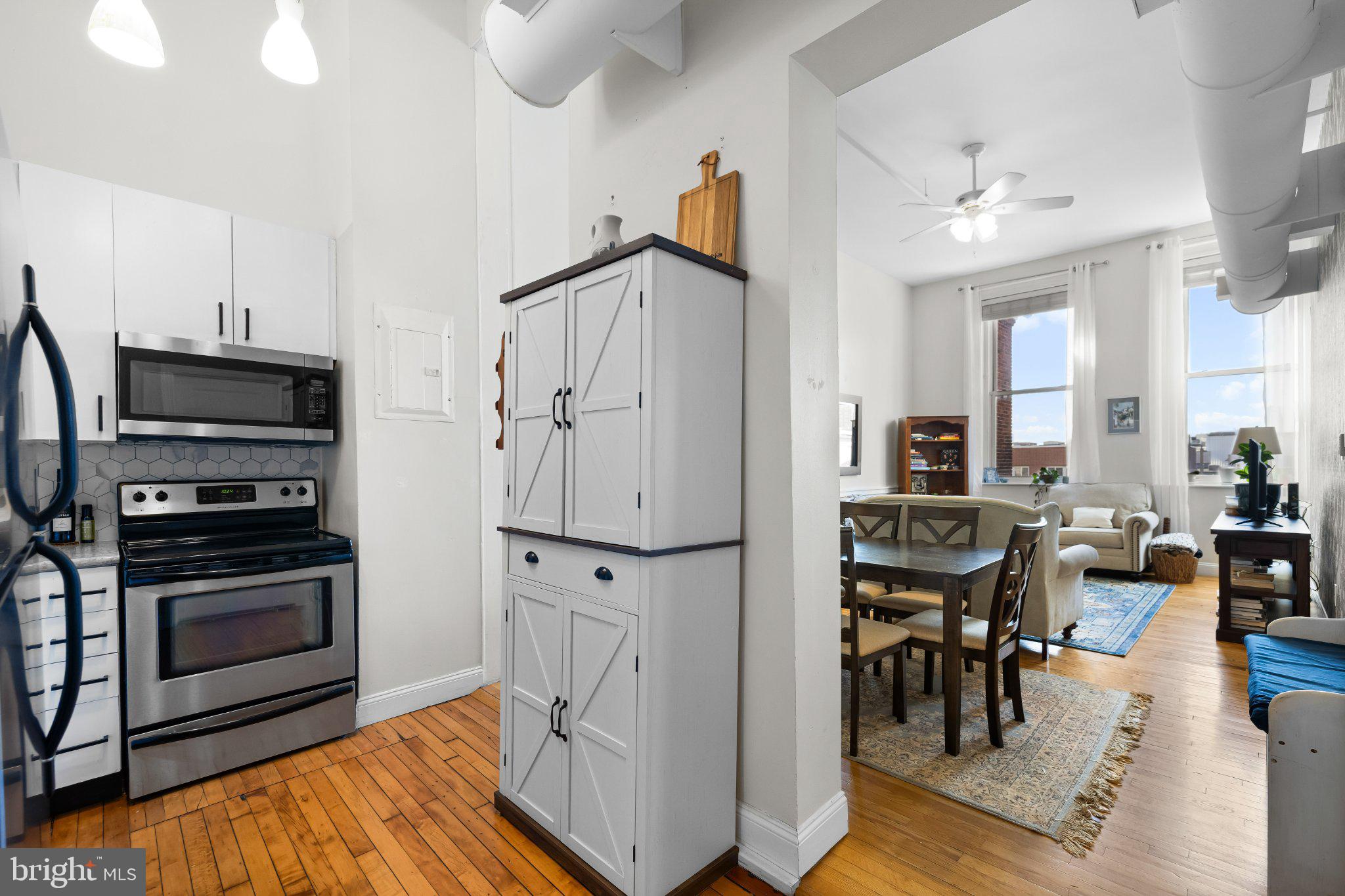 511 South Bond Street, Unit 302 Baltimore, MD 21231 - Photo 5 of 24 a living room with stainless steel appliances furniture a fireplace and a open kitchen view