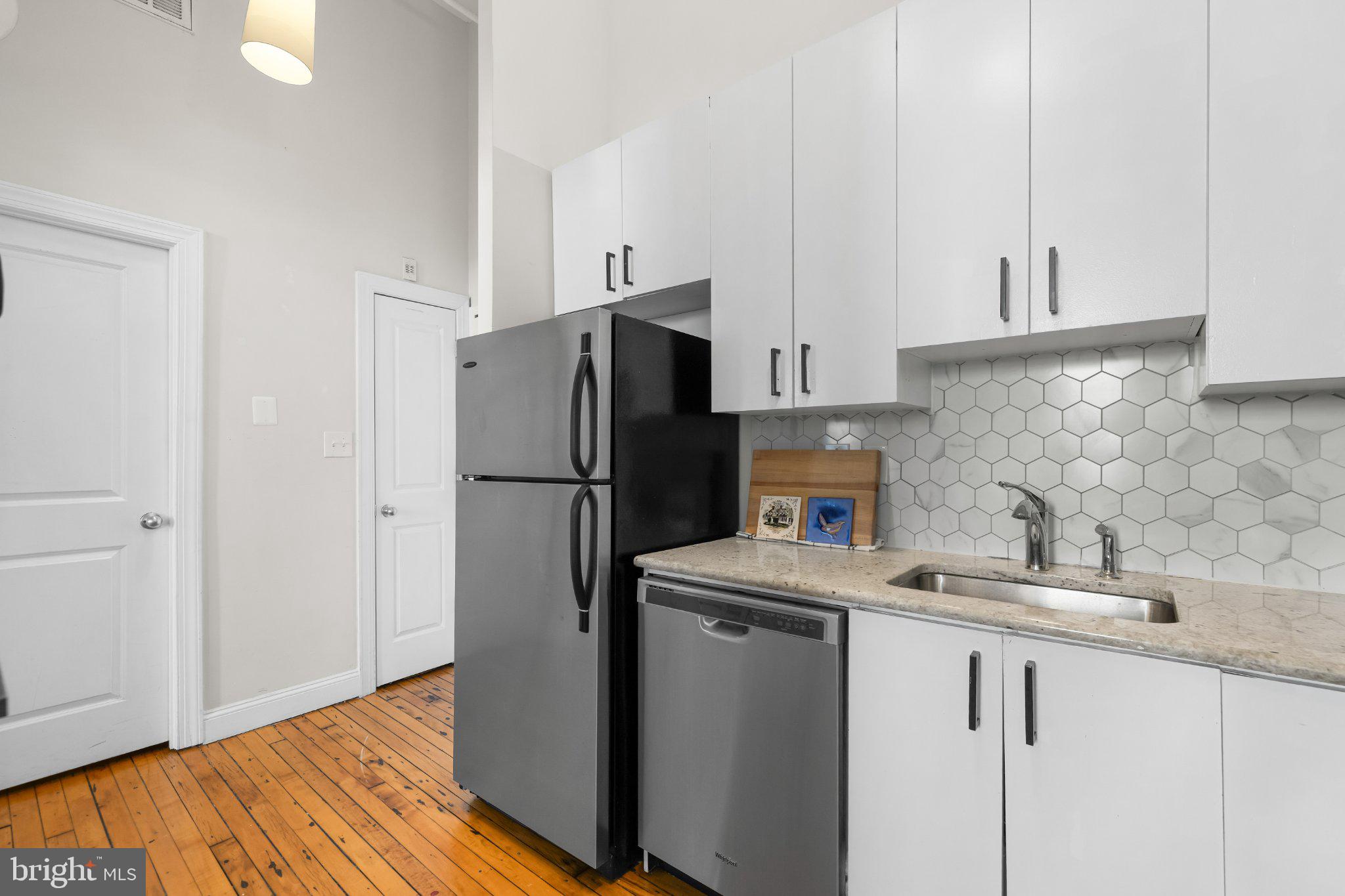 511 South Bond Street, Unit 302 Baltimore, MD 21231 - Photo 7 of 24 a kitchen with stainless steel appliances a refrigerator and a sink