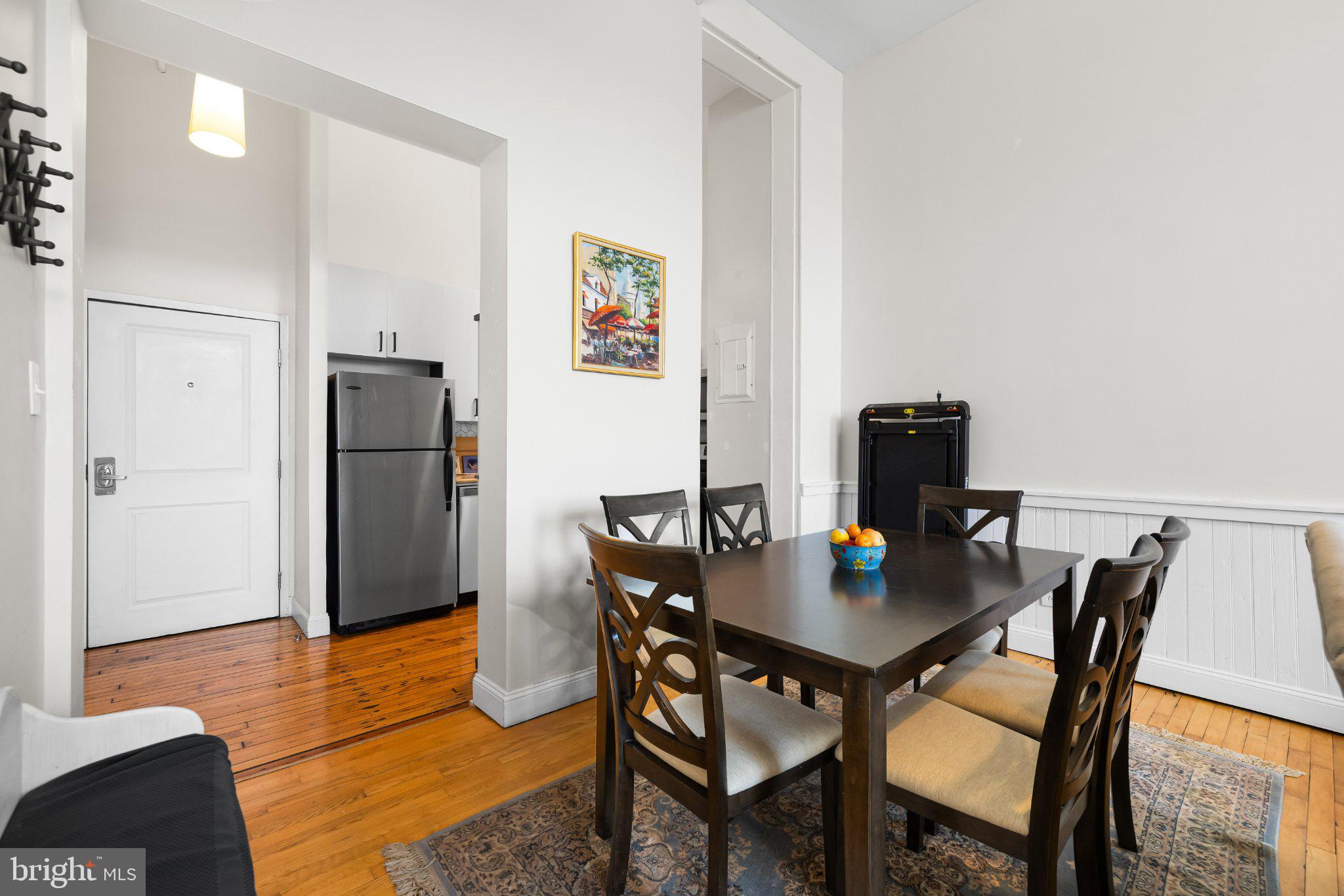 511 South Bond Street, Unit 302 Baltimore, MD 21231 - Photo 9 of 24 a view of a dining room with furniture and a table in a kitchen