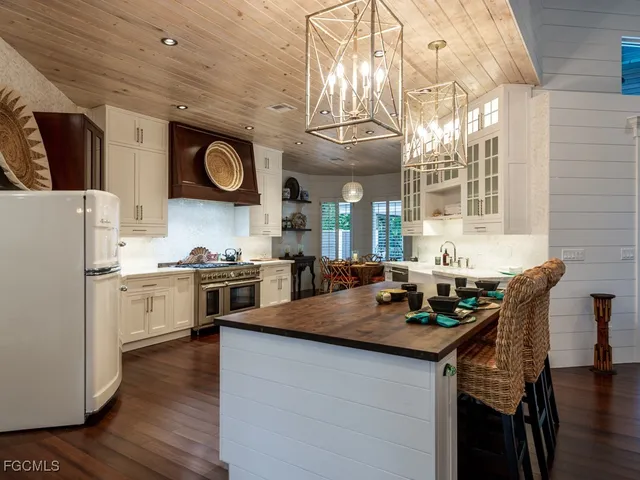 a kitchen with a stove cabinets and wooden floor