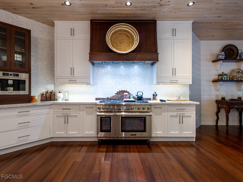 2388 Wulfert Road Sanibel, FL 33957 - Photo 13 of 49 a kitchen with cabinets and wooden floor
