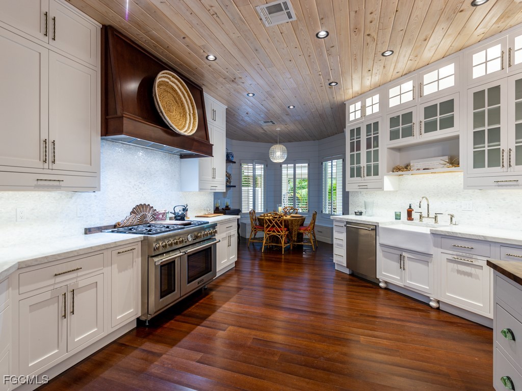 2388 Wulfert Road Sanibel, FL 33957 - Photo 14 of 49 a kitchen with a stove cabinets and wooden floor