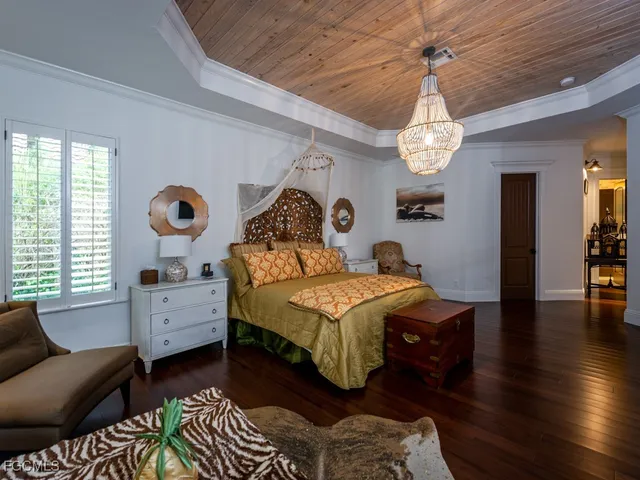 a view of hall way with furniture and chandelier
