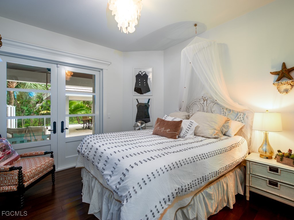 2388 Wulfert Road Sanibel, FL 33957 - Photo 27 of 49 a bedroom with a bed and a dresser