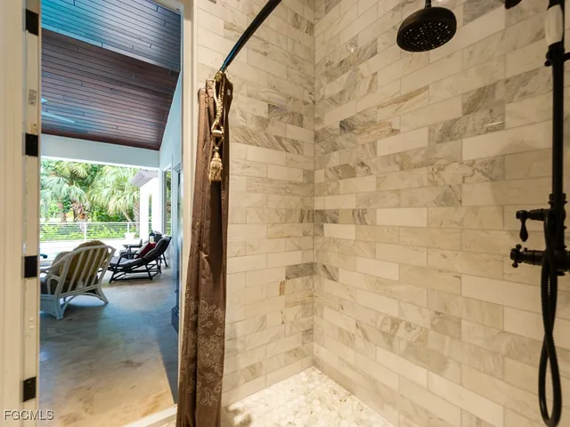 a front view of a house with a yard and potted plants