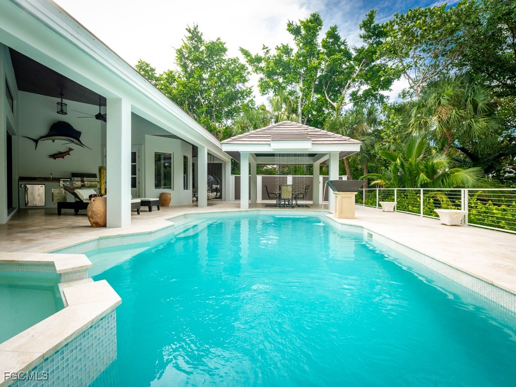 2388 Wulfert Road Sanibel, FL 33957 - Photo 30 of 49 a view of a house with a swimming pool