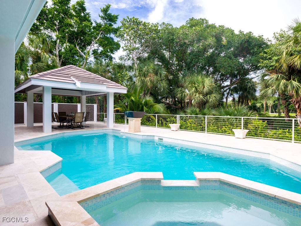 2388 Wulfert Road Sanibel, FL 33957 - Photo 31 of 49 a view of a swimming pool with a patio