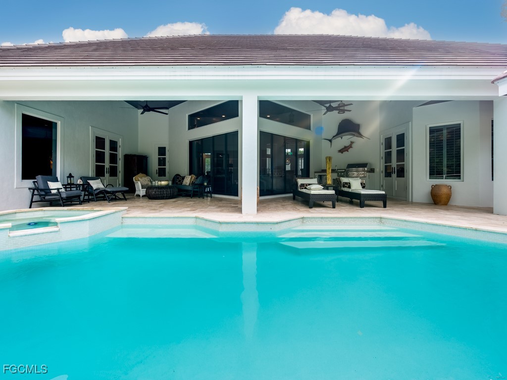 2388 Wulfert Road Sanibel, FL 33957 - Photo 40 of 49 a view of a patio with table and chairs a barbeque with wooden fence