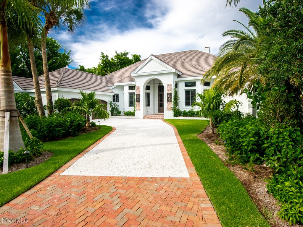 2388 Wulfert Road Sanibel, FL 33957 - Photo 41 of 49 a view of a white house with a yard and potted plants