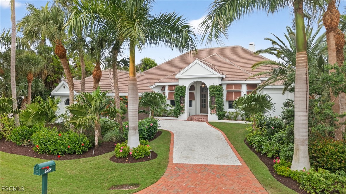 2388 Wulfert Road Sanibel, FL 33957 - Photo 42 of 50 a front view of a house with a yard and potted plants