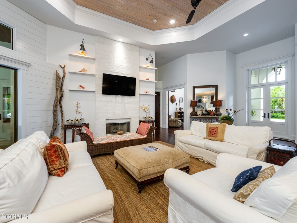 2388 Wulfert Road Sanibel, FL 33957 - Photo 6 of 49 a living room with furniture a fireplace and a flat screen tv