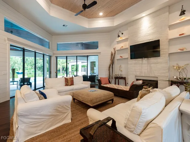 a living room with furniture fireplace and flat screen tv
