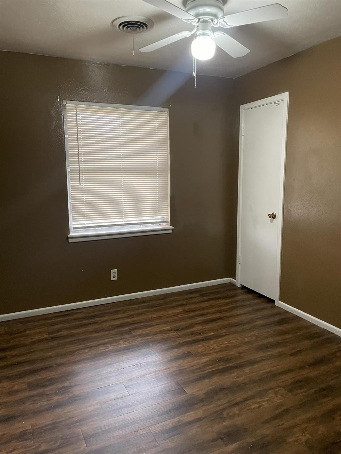 5424 45th Street Lubbock, TX 79414 - Photo 11 of 16 an empty room with wooden floor and windows