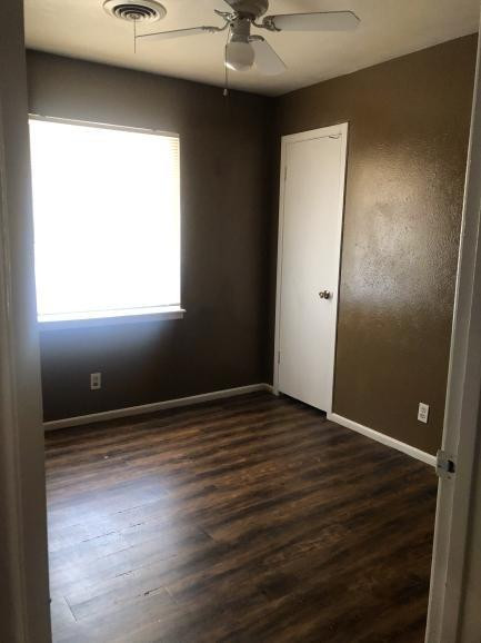 5424 45th Street Lubbock, TX 79414 - Photo 14 of 16 an empty room with wooden floor and a window