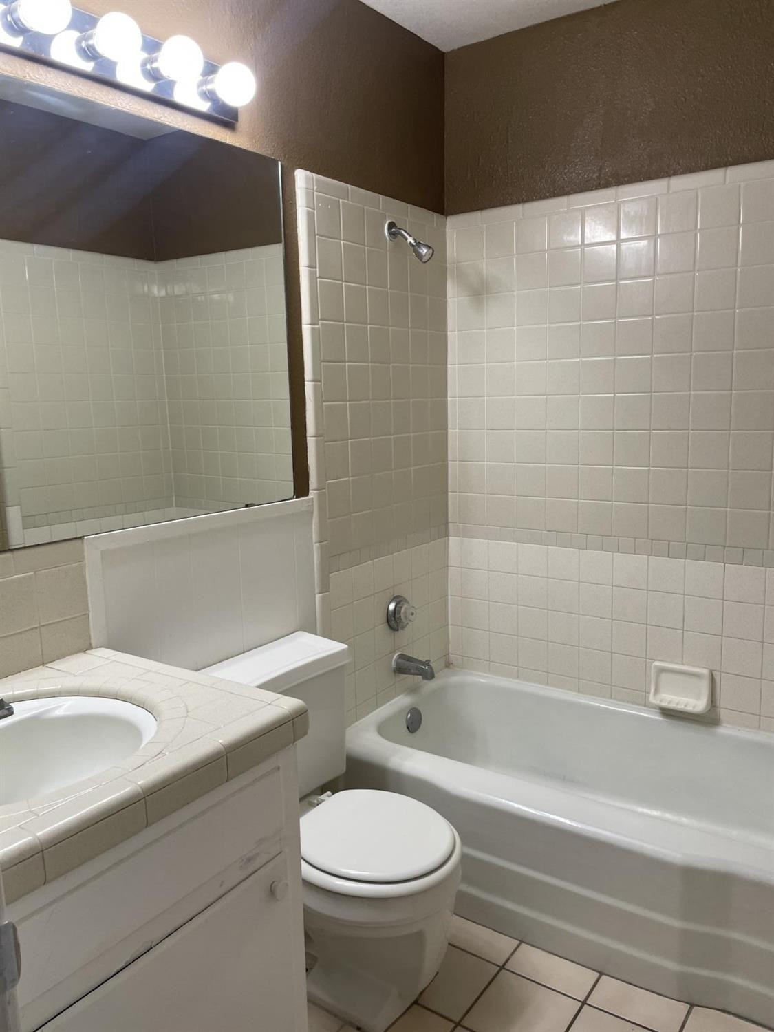 5424 45th Street Lubbock, TX 79414 - Photo 15 of 16 a bathroom with a sink a toilet and bathtub