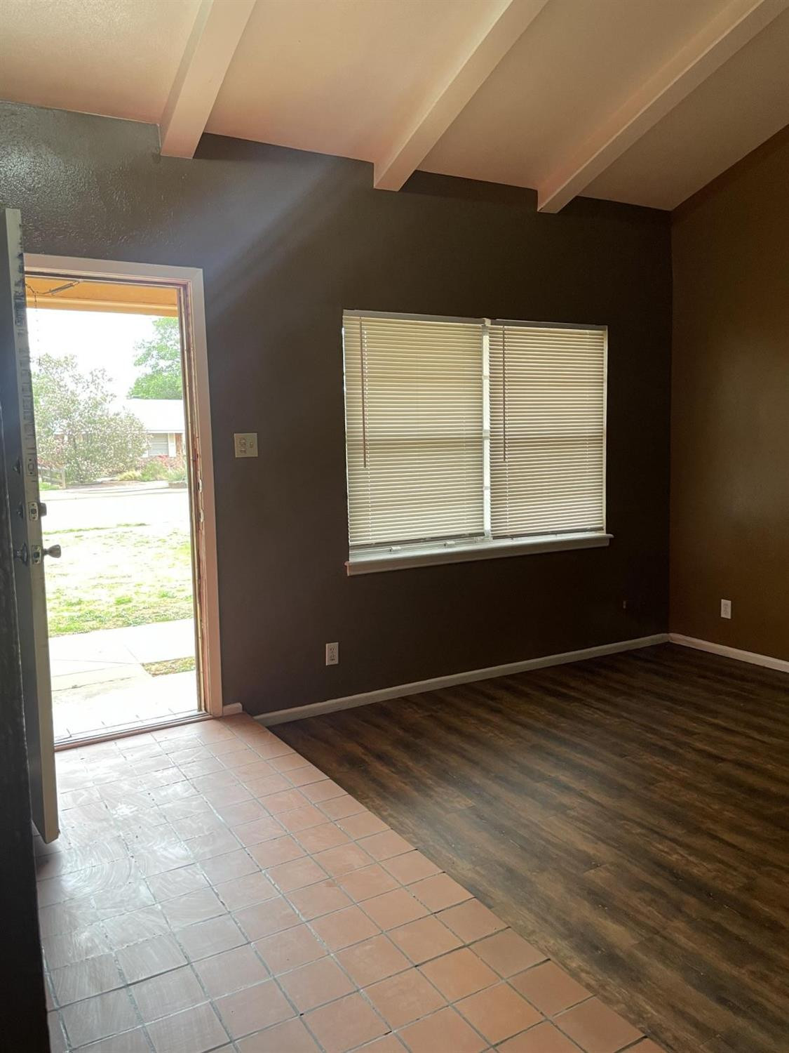 5424 45th Street Lubbock, TX 79414 - Photo 3 of 16 an empty room with wooden floor and windows