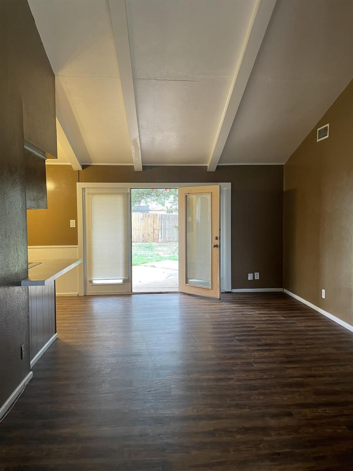 5424 45th Street Lubbock, TX 79414 - Photo 5 of 16 a view of an empty room with wooden floor and a window