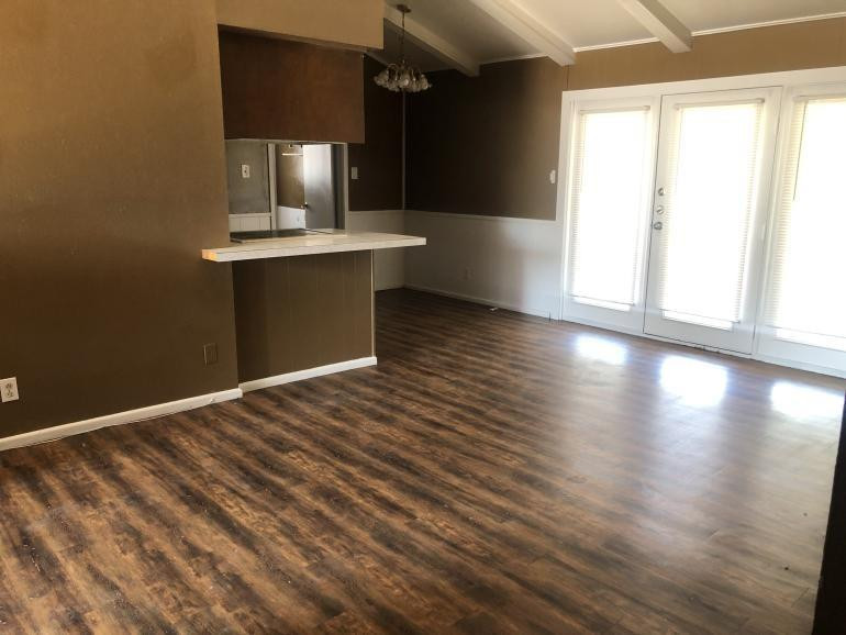 5424 45th Street Lubbock, TX 79414 - Photo 6 of 16 a view of a room with wooden floor and staircase