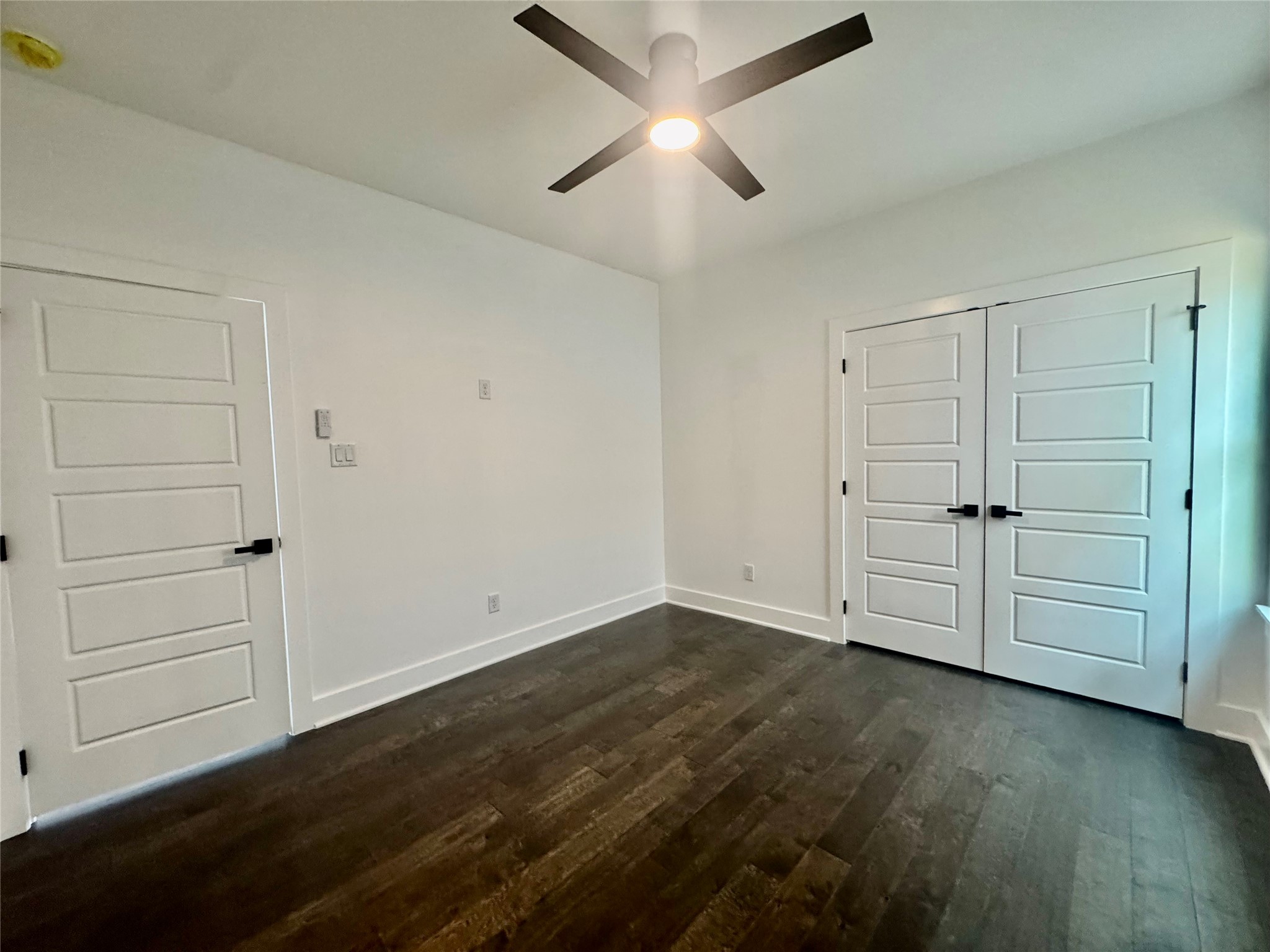 6926 Paris Street, Unit A Houston, TX 77021 - Photo 18 of 20 an empty room with wooden floor closet and windows