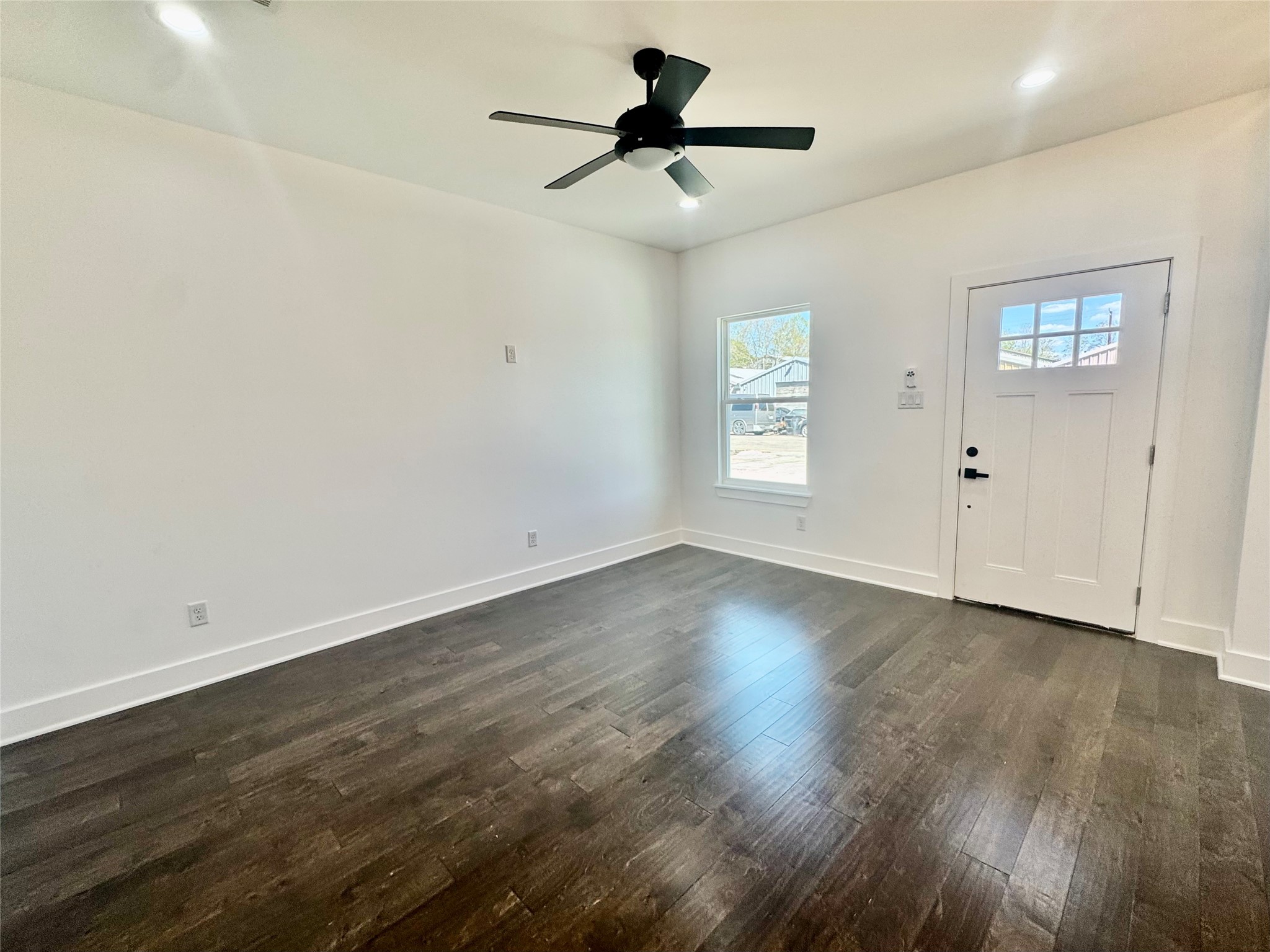 6926 Paris Street, Unit A Houston, TX 77021 - Photo 2 of 20 an empty room with wooden floor and windows