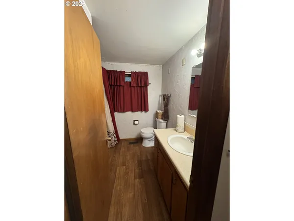 a very nice looking room with a white bed and a dresser