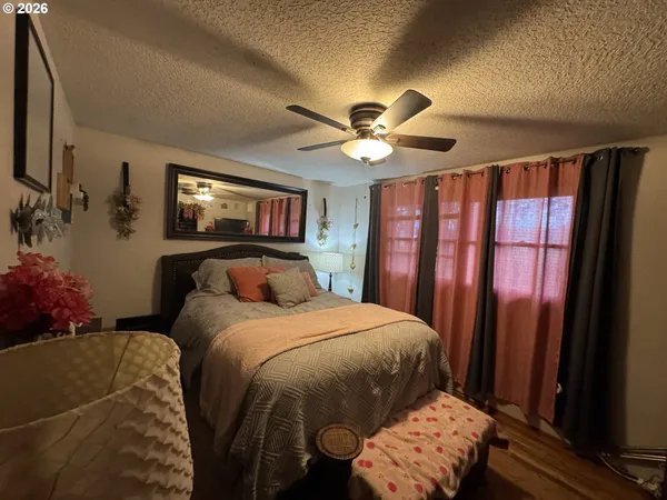 a bedroom with a large bed and a chandelier