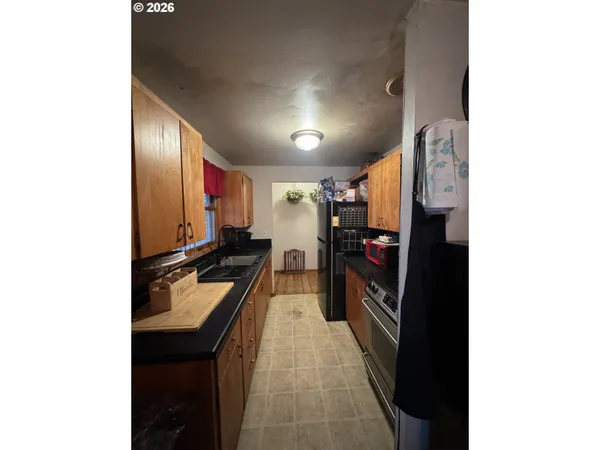 a hallway with a large mirror and a refrigerator