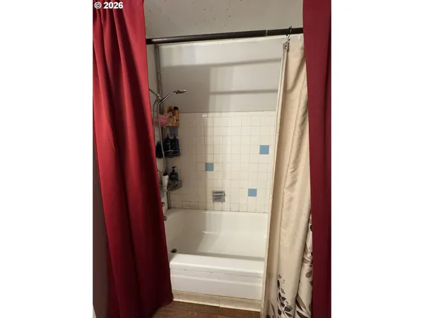 a bathroom with a shower and a door