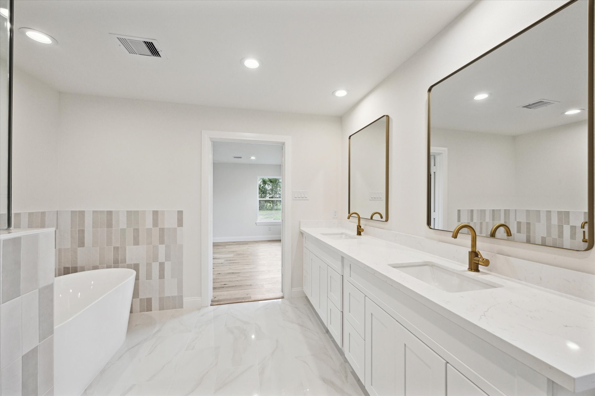1935 Willow Road Wallis, TX 77485 - Photo 22 of 34 Luxurious primary bathroom featuring double sinks and a stylish standalone tub.