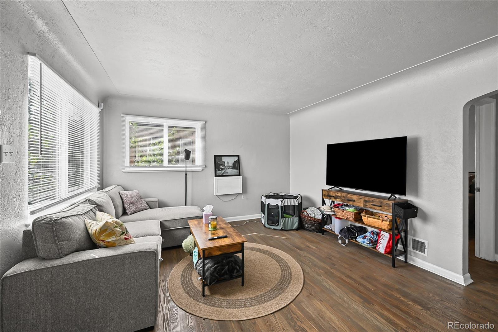 2245 Ames Street Edgewater, CO 80214 - Photo 16 of 21 a living room with furniture and a flat screen tv
