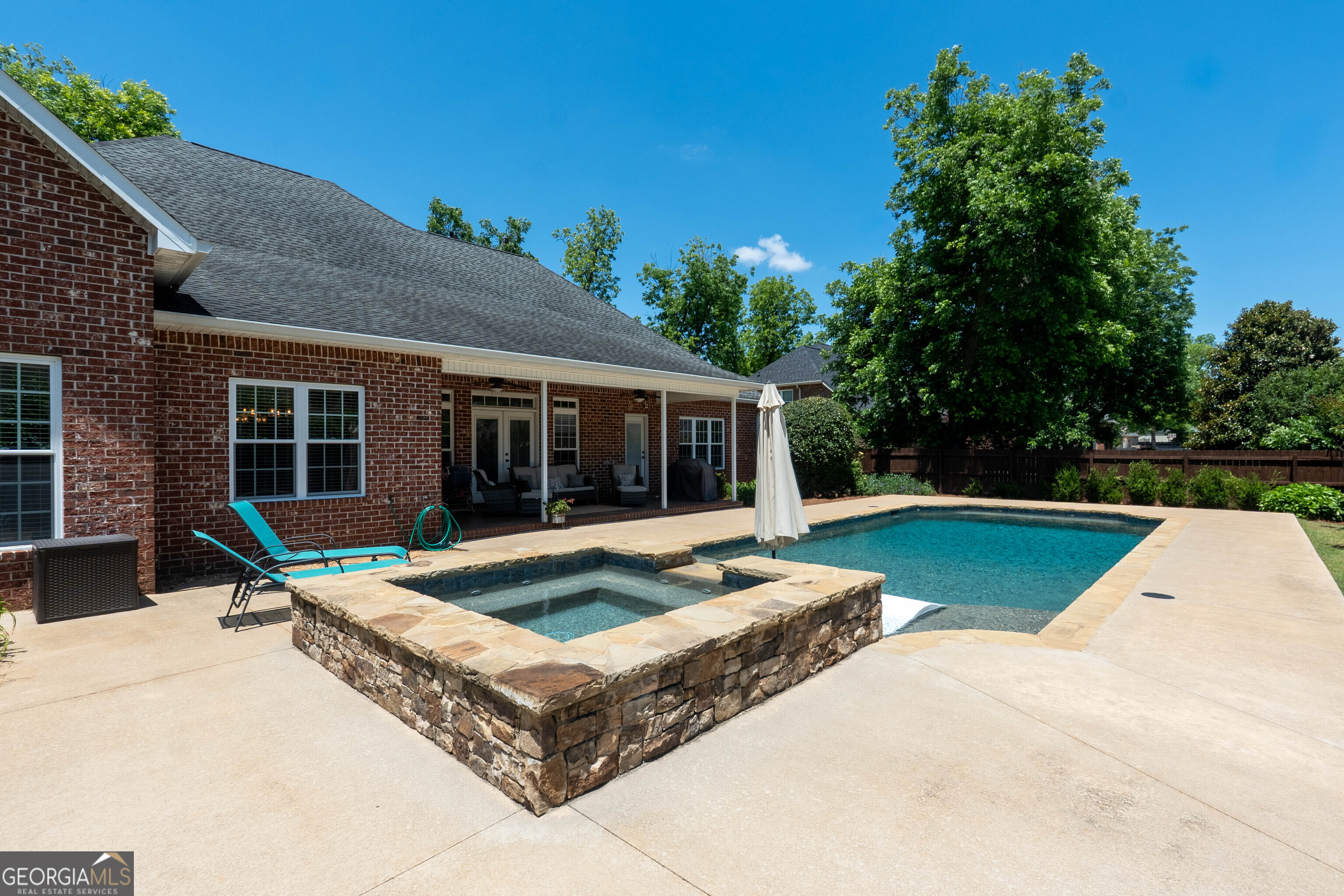 501 Old Bridge Road Warner Robins, GA 31088 - Photo 51 of 54 a house view with swimming pool and wooden bench